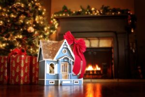 small-dollhouse-with-red-bow-beneath-christmas-tree