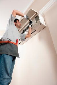 HVAC-installer-working-on-a-ductless-air-handler